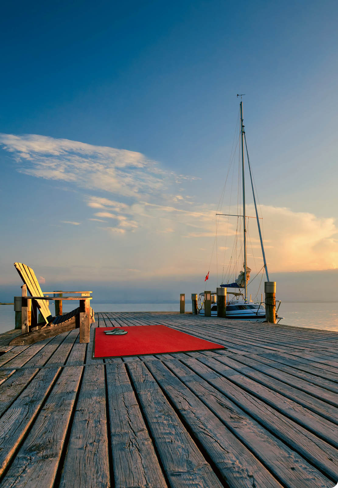 Lighthouse at Lake Neusiedl at sunset near Podersdorf with sea gulls flying around the lighthouse. Burgenland, Austria